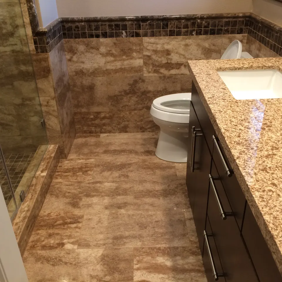 Custom bathroom tile installation with natural stone accent wall