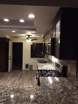 Dark granite kitchen countertops with stainless steel appliances in Chino home
