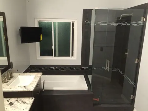 Dark granite vanity countertop with vessel sink in Inland Empire bathroom