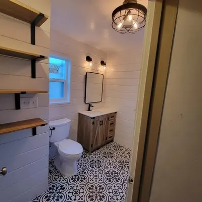 Floating vanity with open shelving and vessel sink in modern Inland Empire bathroom