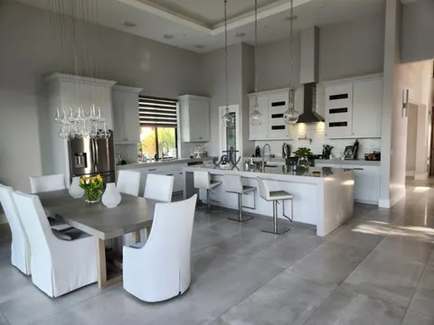 Modern kitchen remodel with white island and pendant lights in Chino, CA