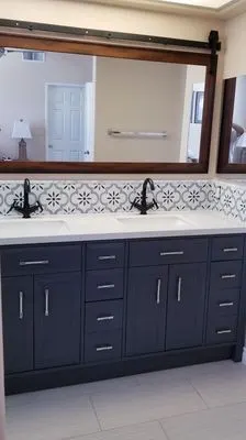 Navy blue double vanity with granite countertop and gold hardware
