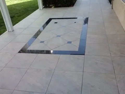 Outdoor patio tile installation with decorative border