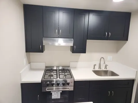 Two-tone navy and white kitchen cabinets in Chino home