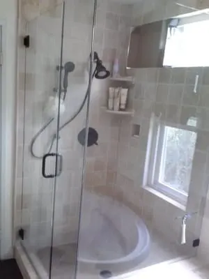 Walk-in glass shower with custom tile work by Rocca Tile