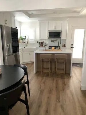 White island cabinets with dark upper cabinets in Inland Empire kitchen