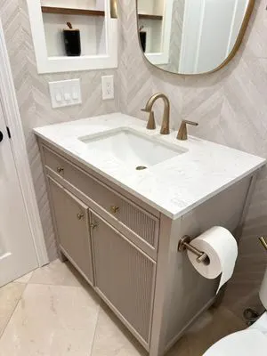 White marble countertop with gold faucet installed by Rocca Tile